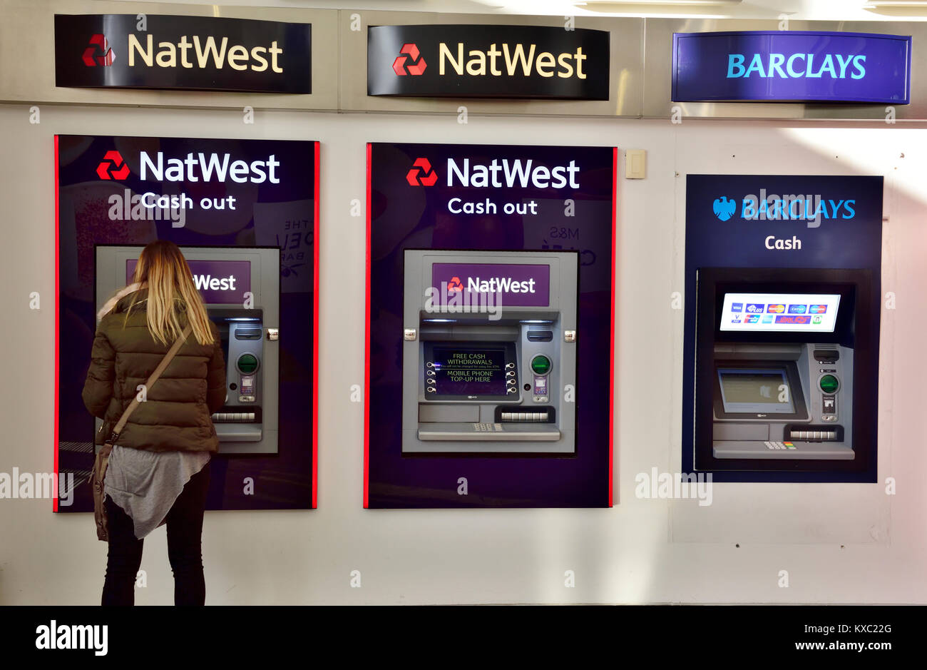 Woman at bank ATM cash machine Stock Photo