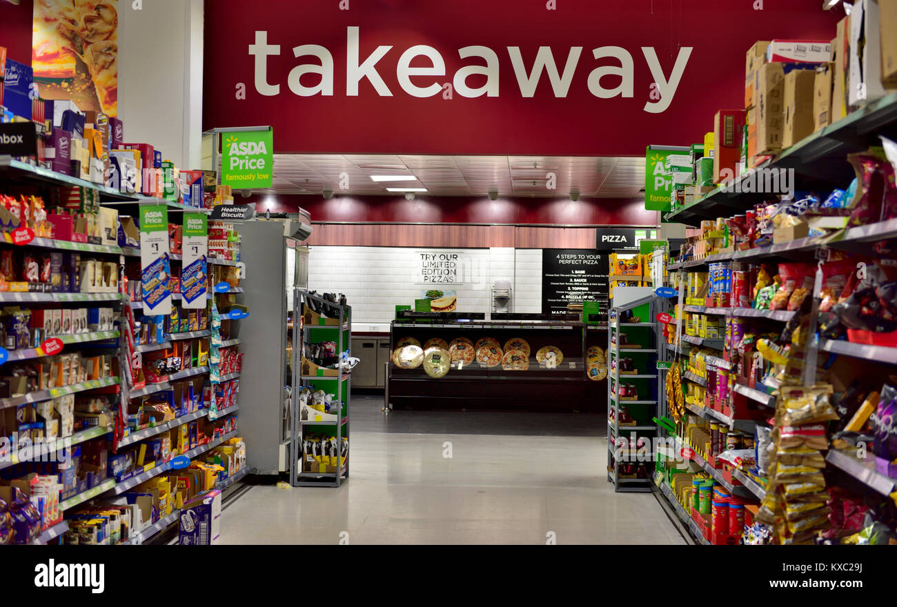 Looking down aisle of supermarket to Takeaway sign above pizzas counter Stock Photo