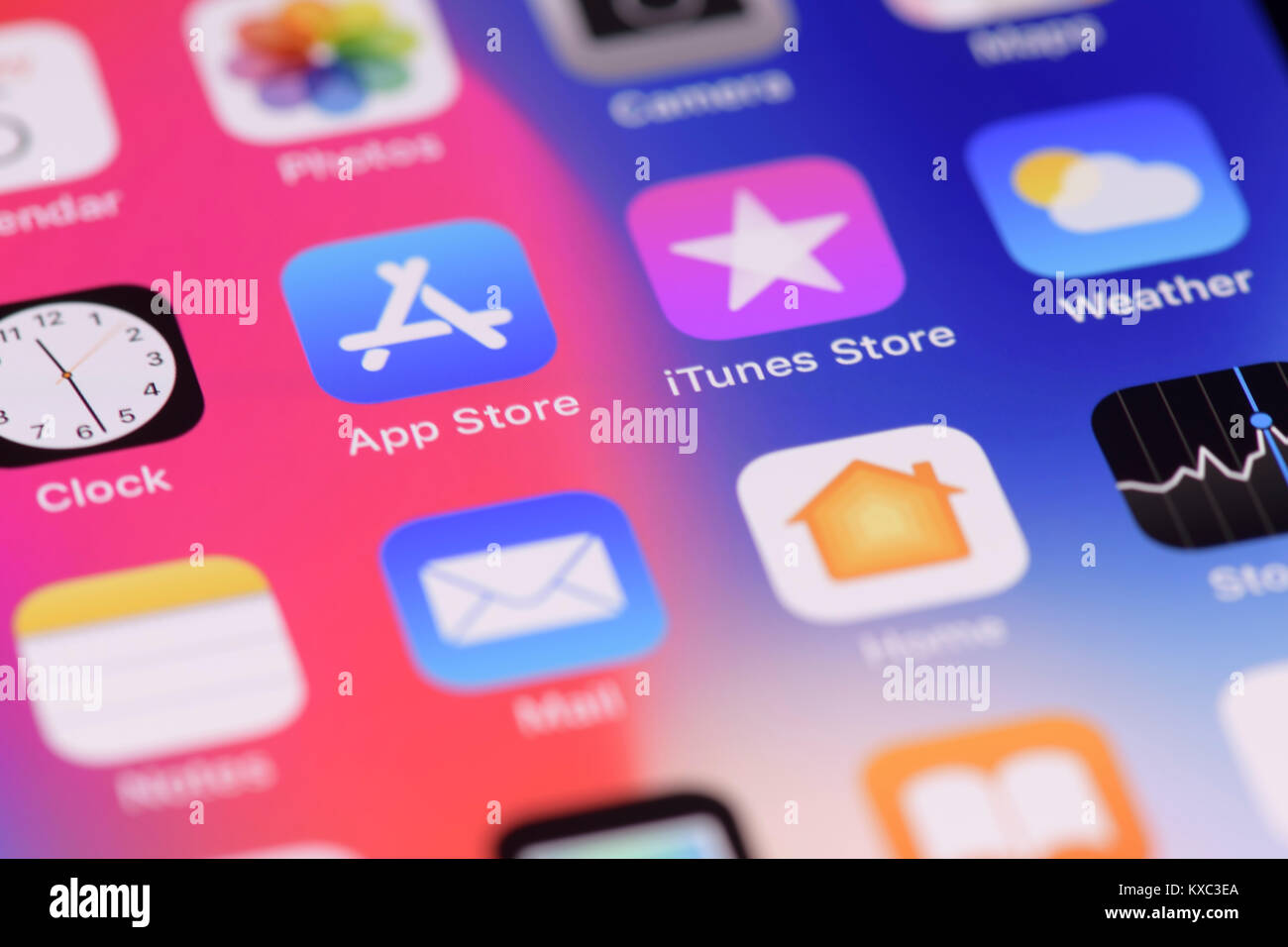 Closeup of iPhone screen with colorful app icons on desktop Stock Photo