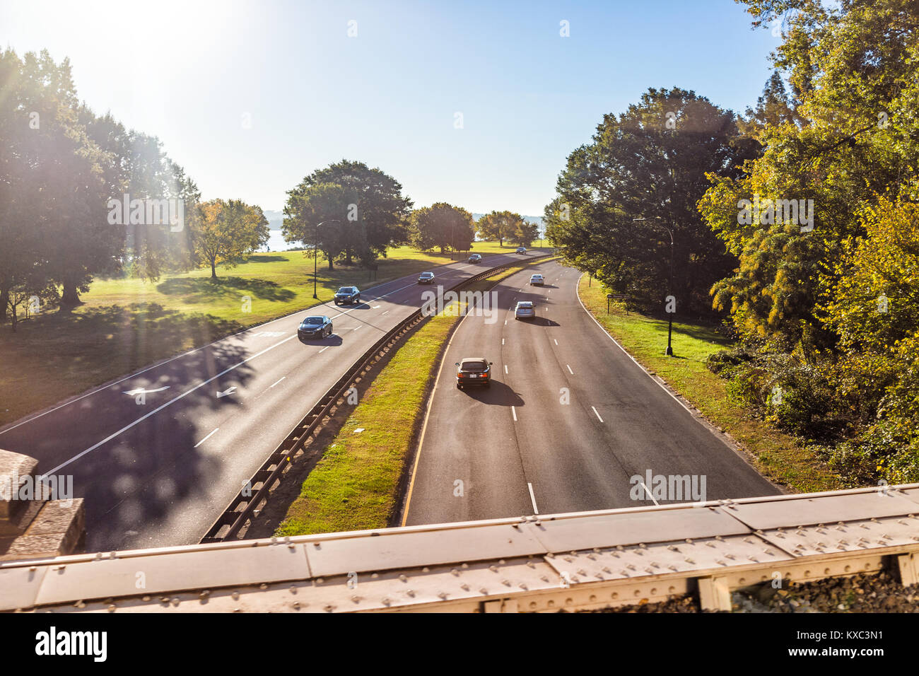 Virginia, USA - October 27, 2017: Aerial view of George Washington Memorial Parkway with cars from overpass, mount Vernon sign and Potomac river, sun Stock Photo