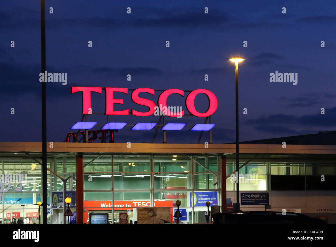 Lights on in Tesco store at night-time with illuminated Tesco sign at Tesco  Supermarket in United Kingdom Stock Photo - Alamy