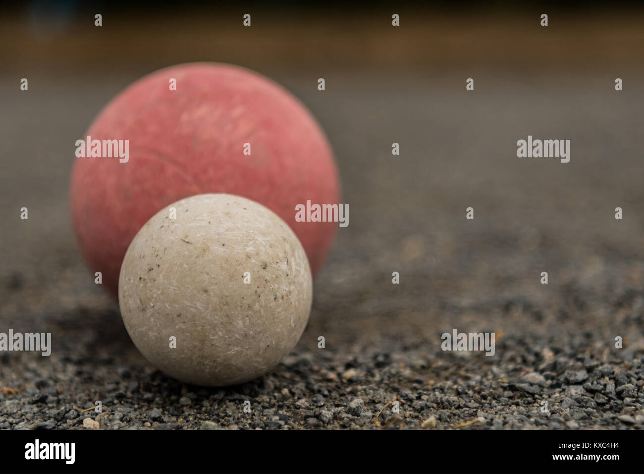 White Bocce Ball with Red Ball with Copy Space Right over gravel