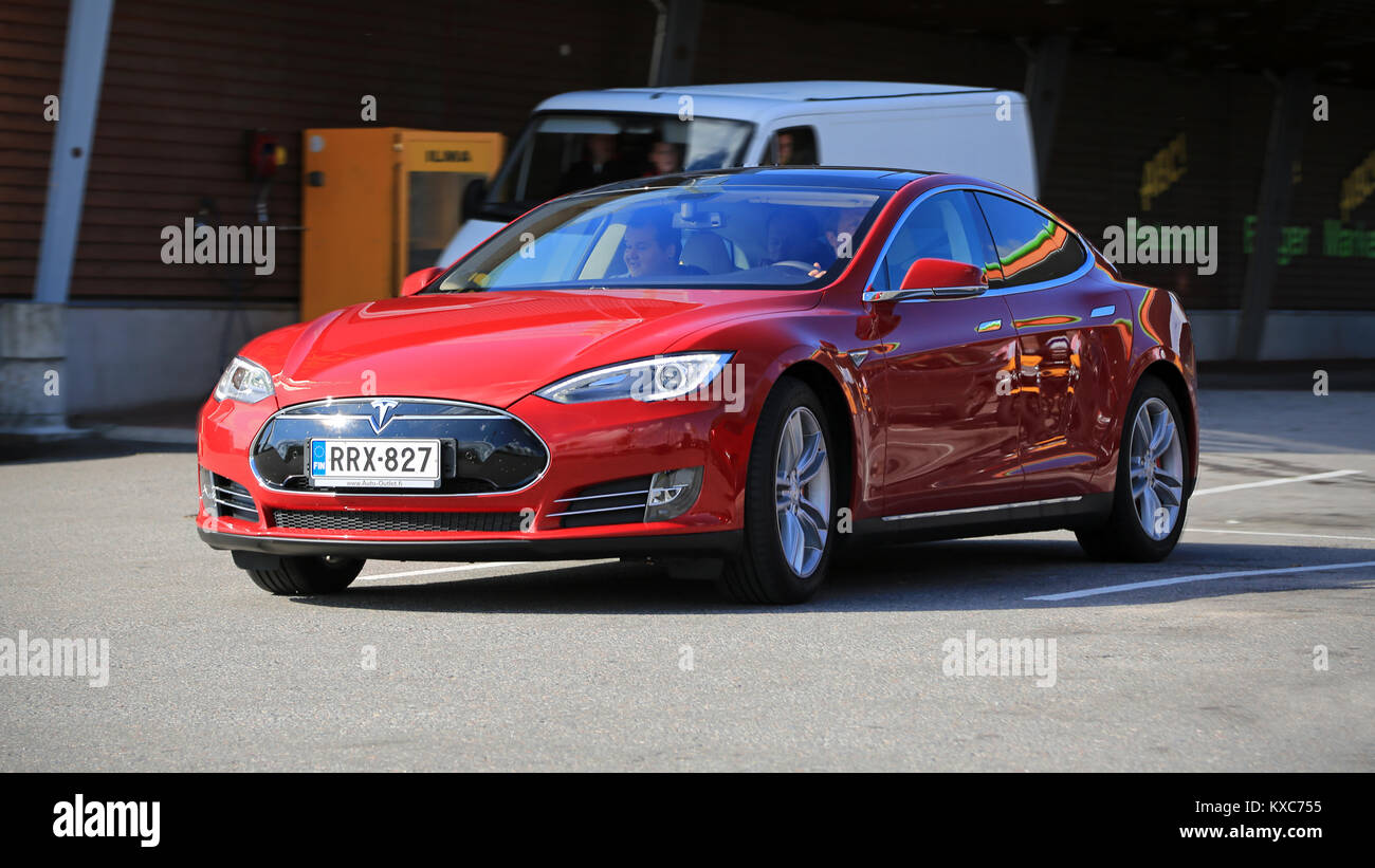 SALO, FINLAND - SEPTEMBER 6, 2014: Tesla Model S fully electric car in motion. In 2013, Tesla delivered 22,477 vehicles to customers worldwide. Stock Photo
