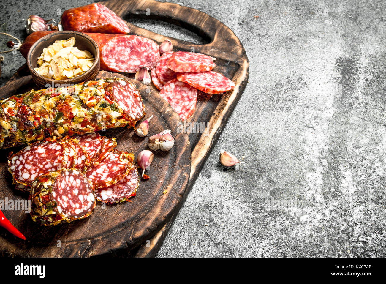 variety of salami with spices and herbs. On a rustic background Stock ...