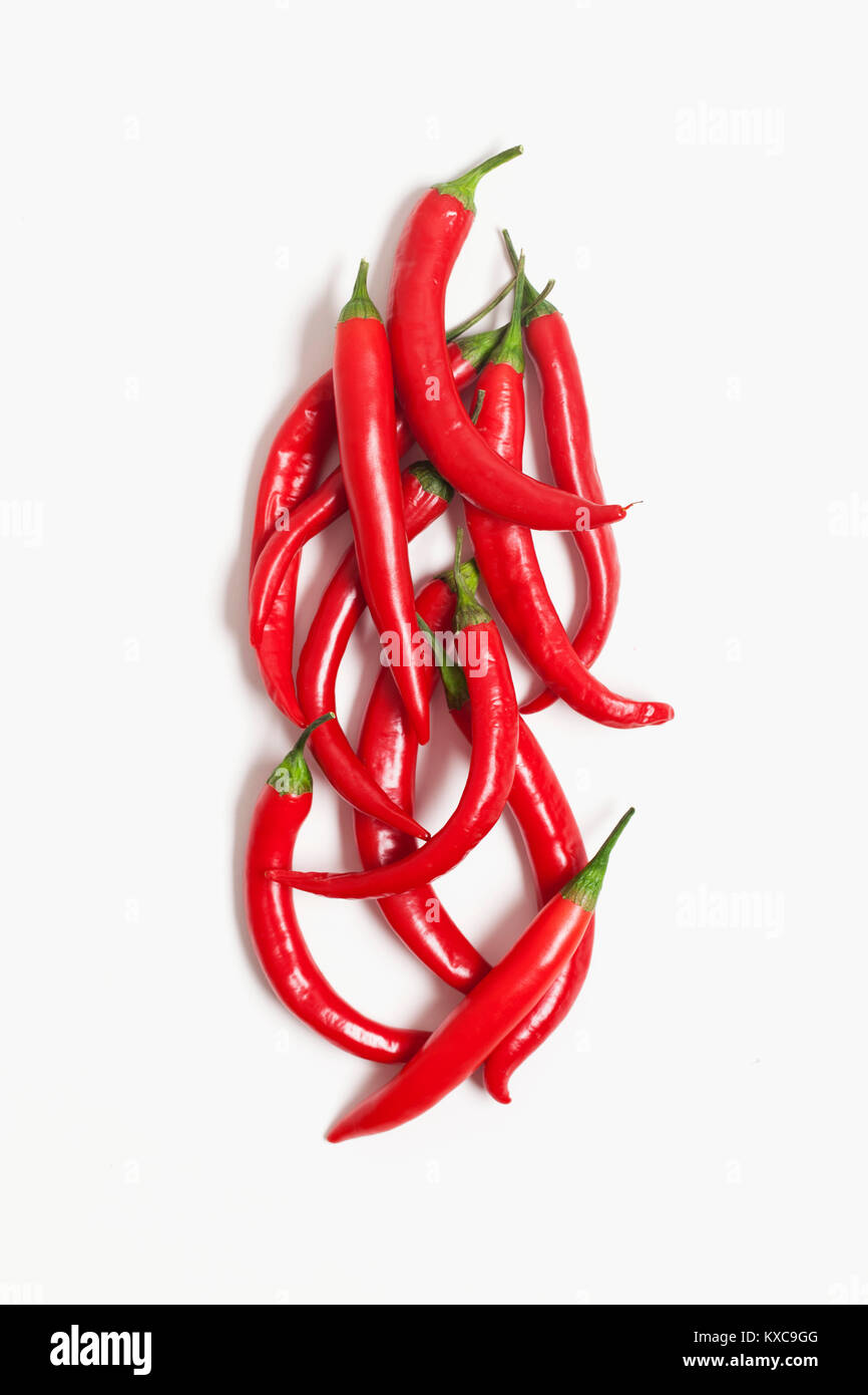 Red fresh chili peppers on a plain white background Stock Photo - Alamy