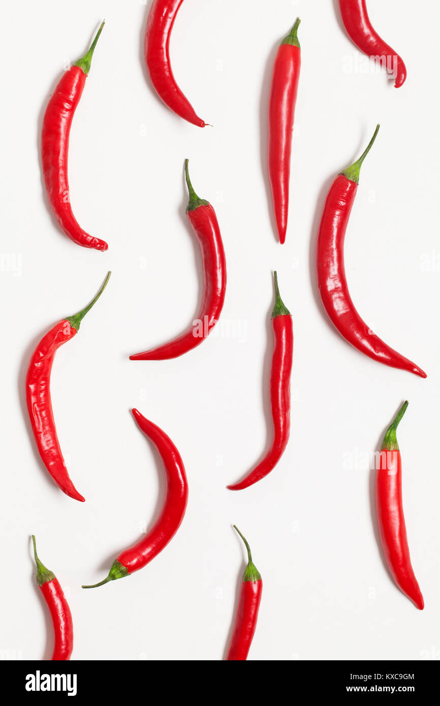 Red fresh chili peppers on a plain white background Stock Photo - Alamy