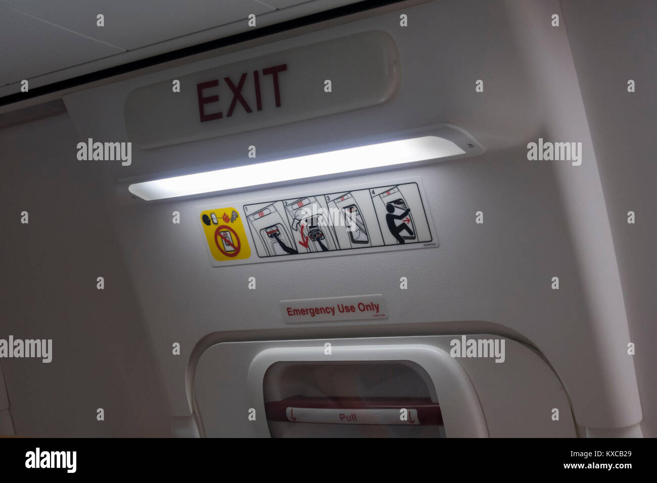 Emergency exit on the inside of an aircraft Stock Photo
