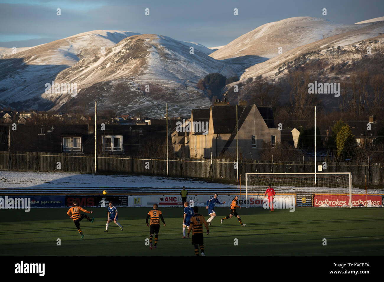 Alloa Athletic take on Peterhead (in blue) in a Scottish League One fixture at Recreation Park, with the Ochil Hills in the background. The club was formed in 1878 as Clackmannan County, changing the name to Alloa Athletic in 1883. The visitors won the match by one goal to nil, watched by a crowd of 504. Stock Photo