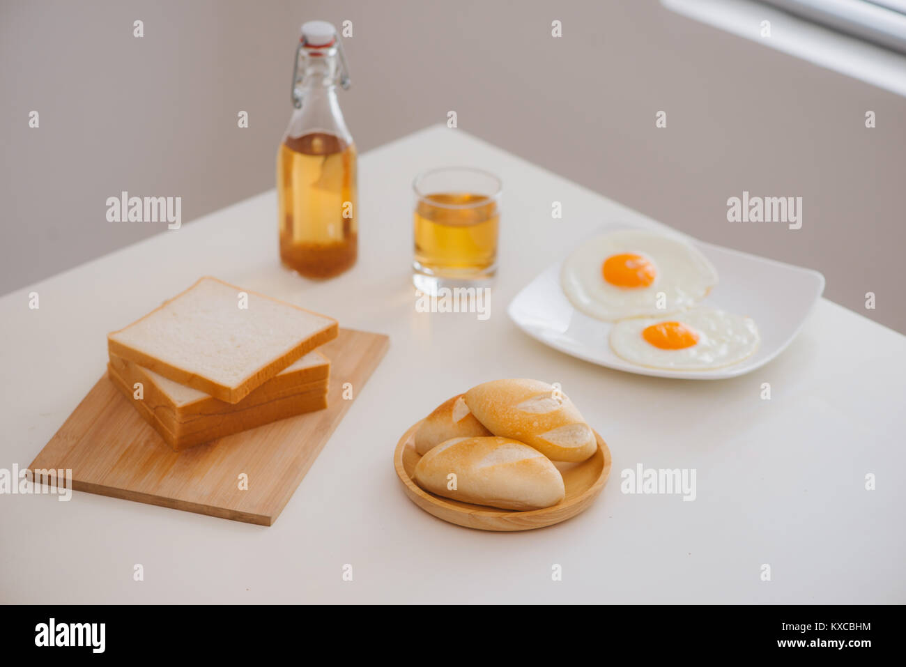 Morning breakfast with glass of tea, toast, fried eggs and bread on ...