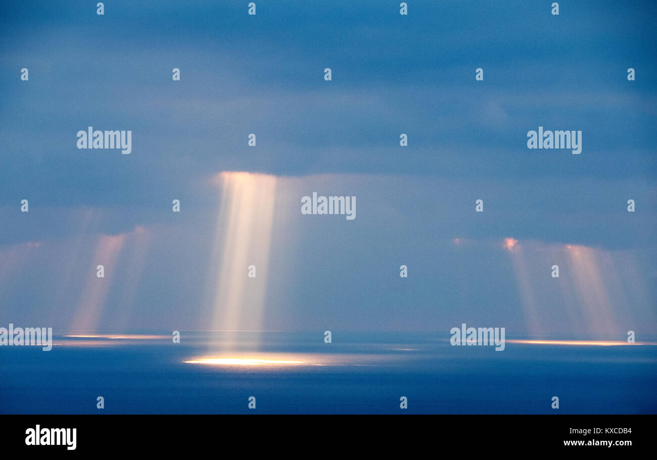 Shafts of sunlight break through the clouds over Coral Bay, near Paphos, Cyprus. Stock Photo