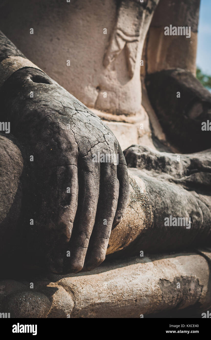 Close up to hand of broken and damaged Buddha statue in Ayutthaya