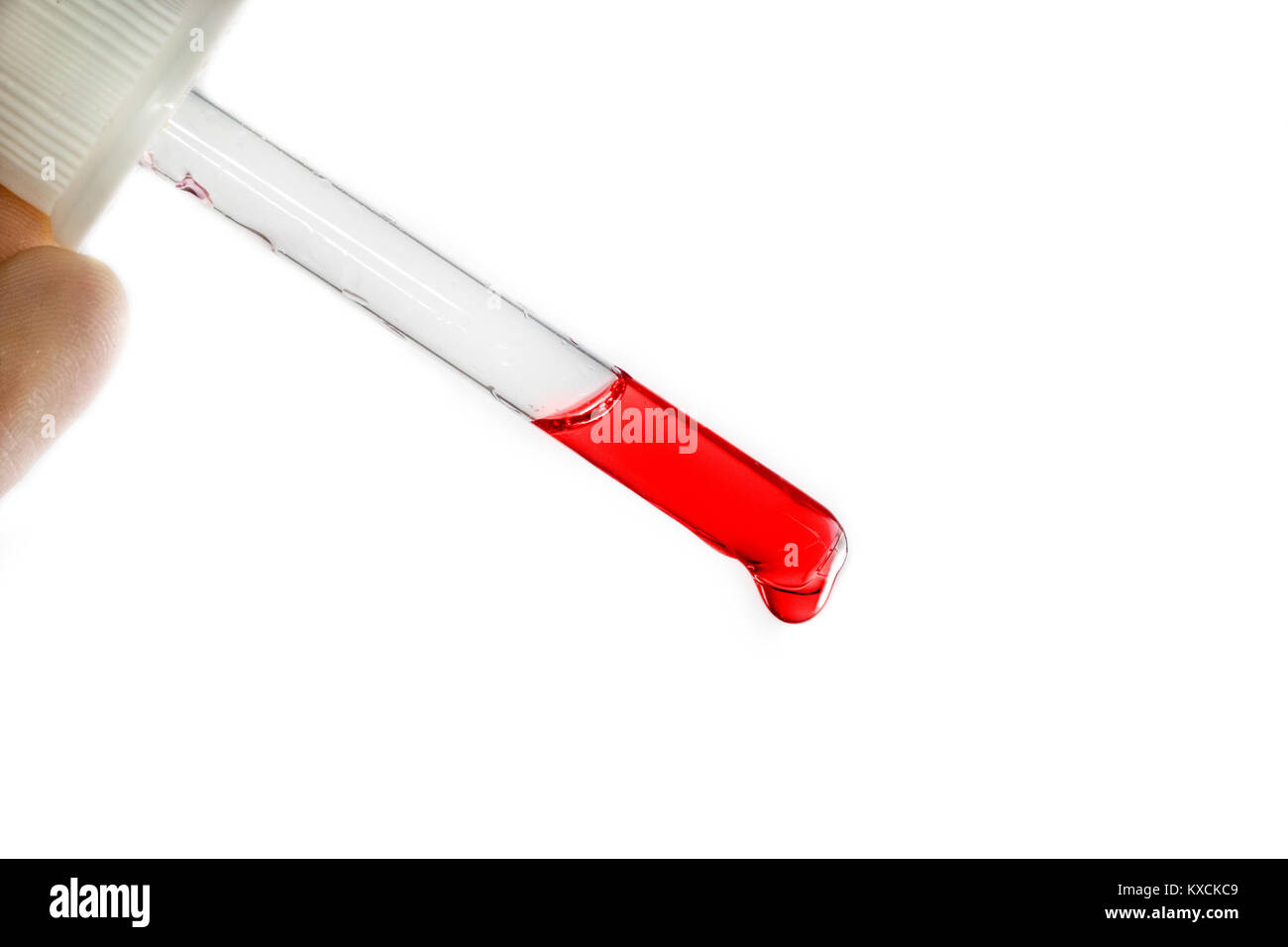 Pipette with red blood liquid substance on a white background, closeup