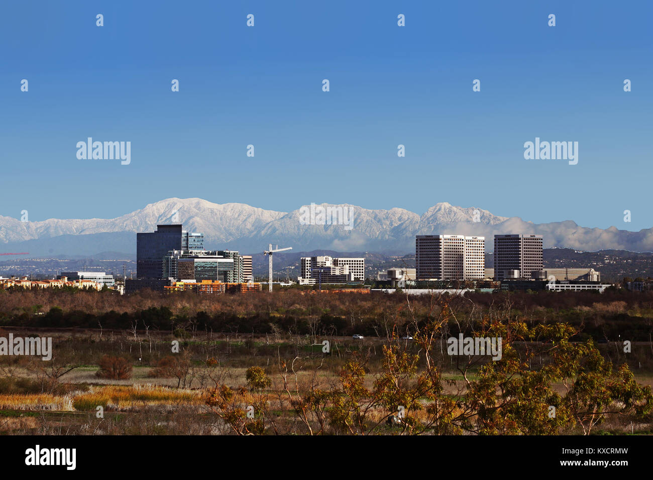 Irvine CA business and hotel district with snow covered Mounty Baldy