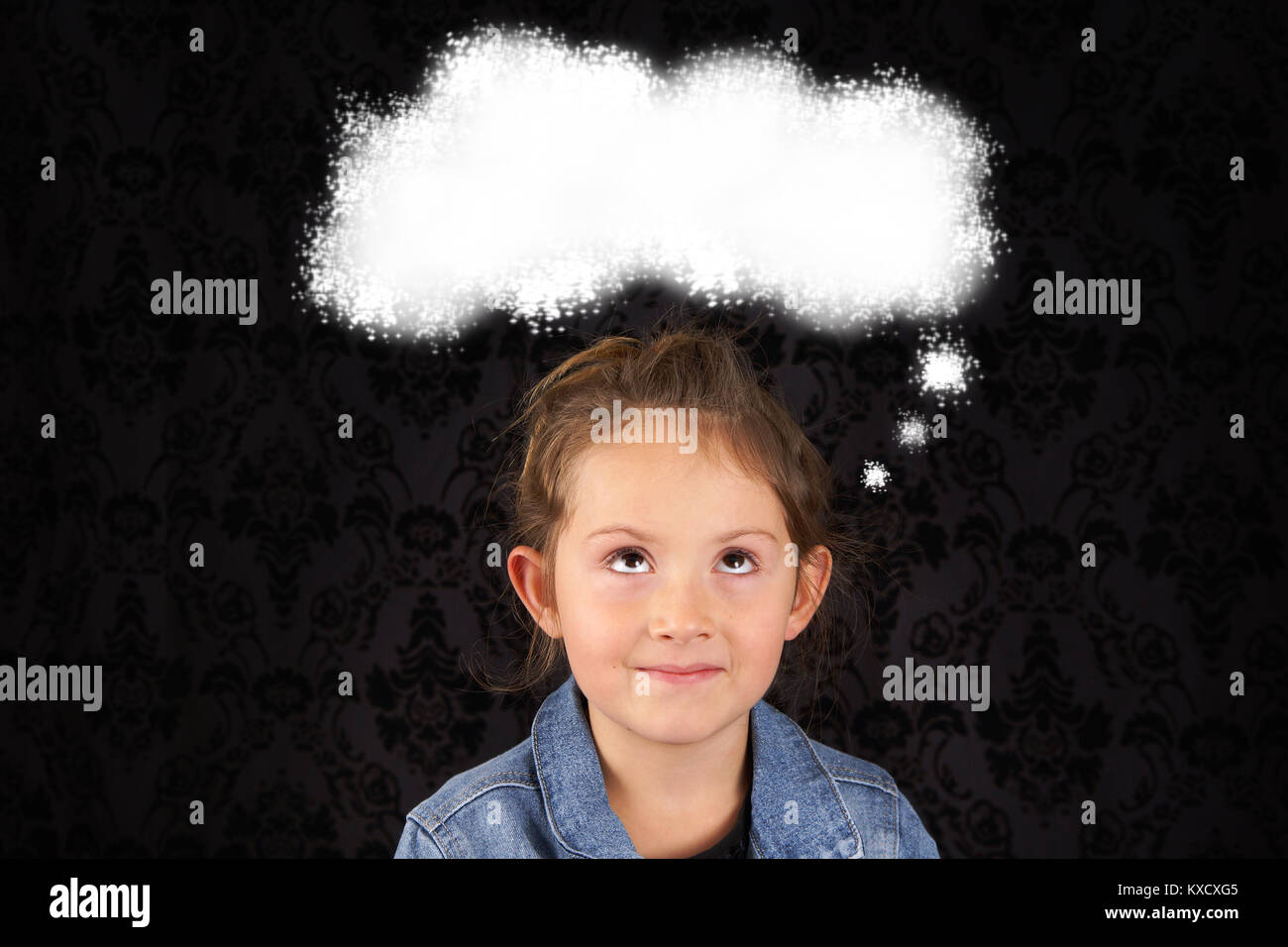 Little girl thinking looking up at thought bubble Stock Photo