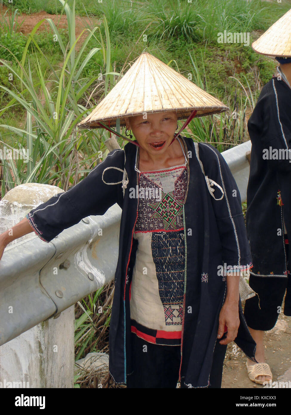 A photograph of a White Dao woman with blackened teeth, representing ...
