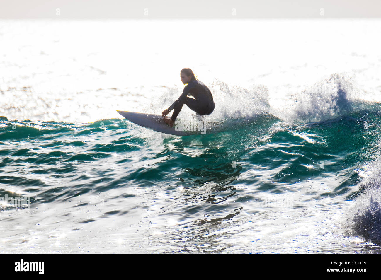 Carefree teenage boy surfing in sea Stock Photo
