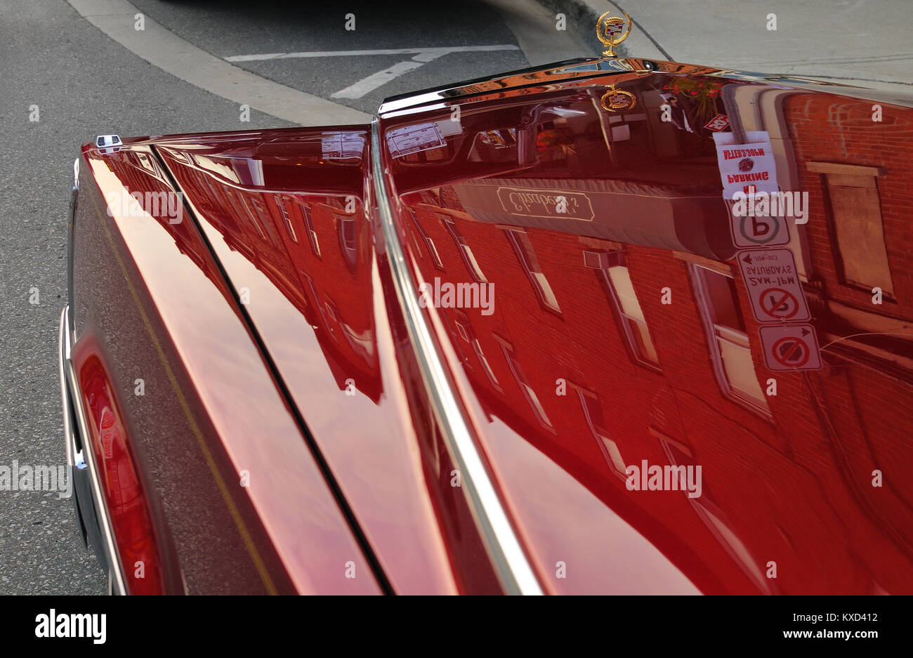 Reflection on the hood of a candy red American luxury car's hood Stock