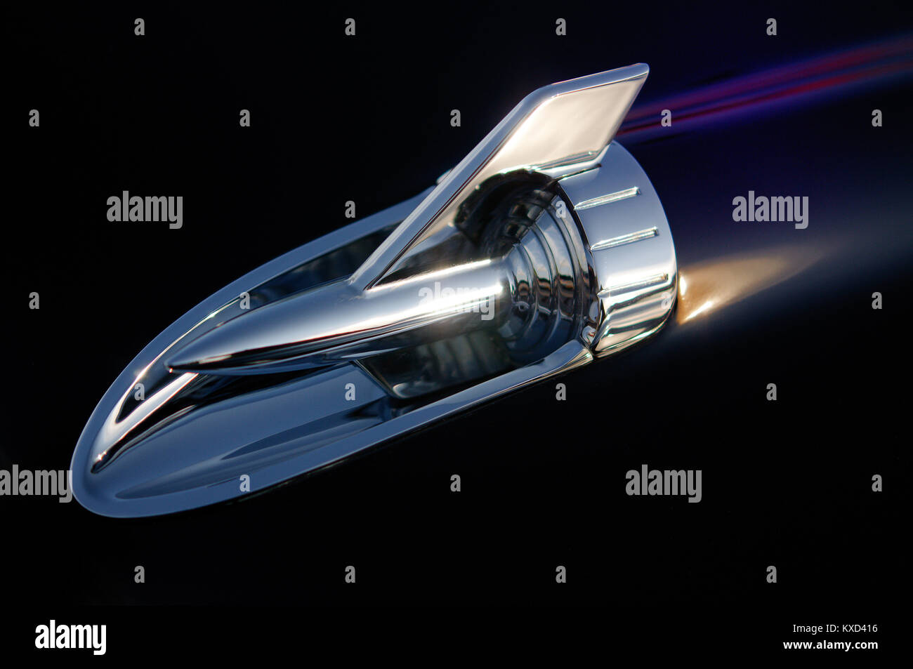 Hood ornament on a 1957 classic American car that resembles a traveling rocket ship in space Stock Photo