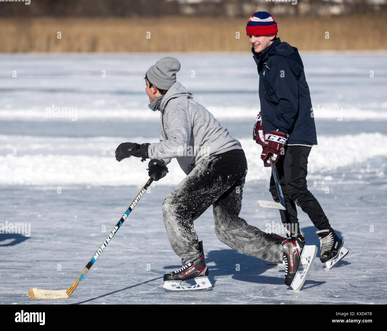 Boys playing ice hockey on a frozen pond on a cold day Stock Photo Alamy