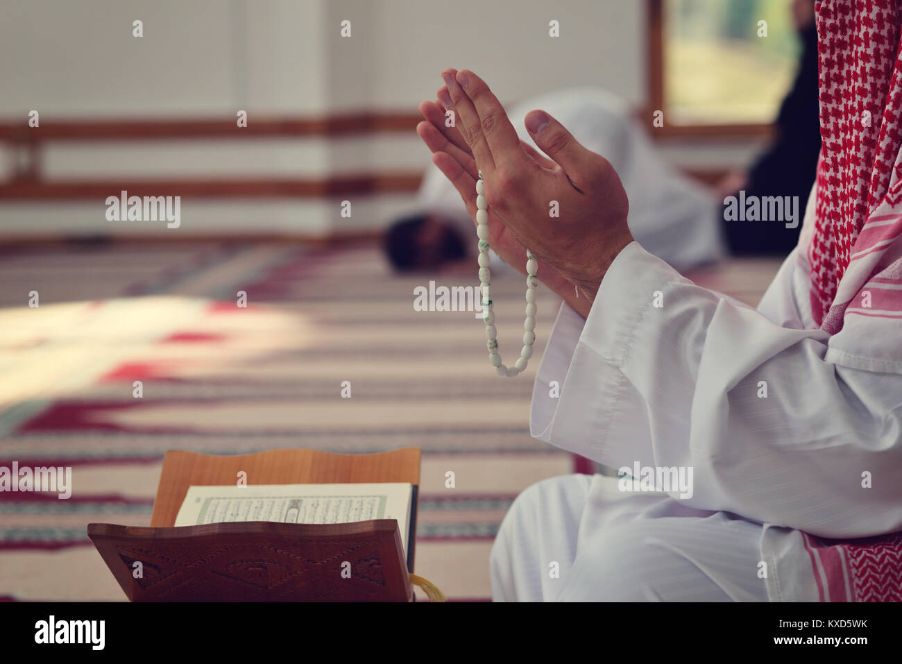 Religious muslim man praying inside the mosque Stock Photo