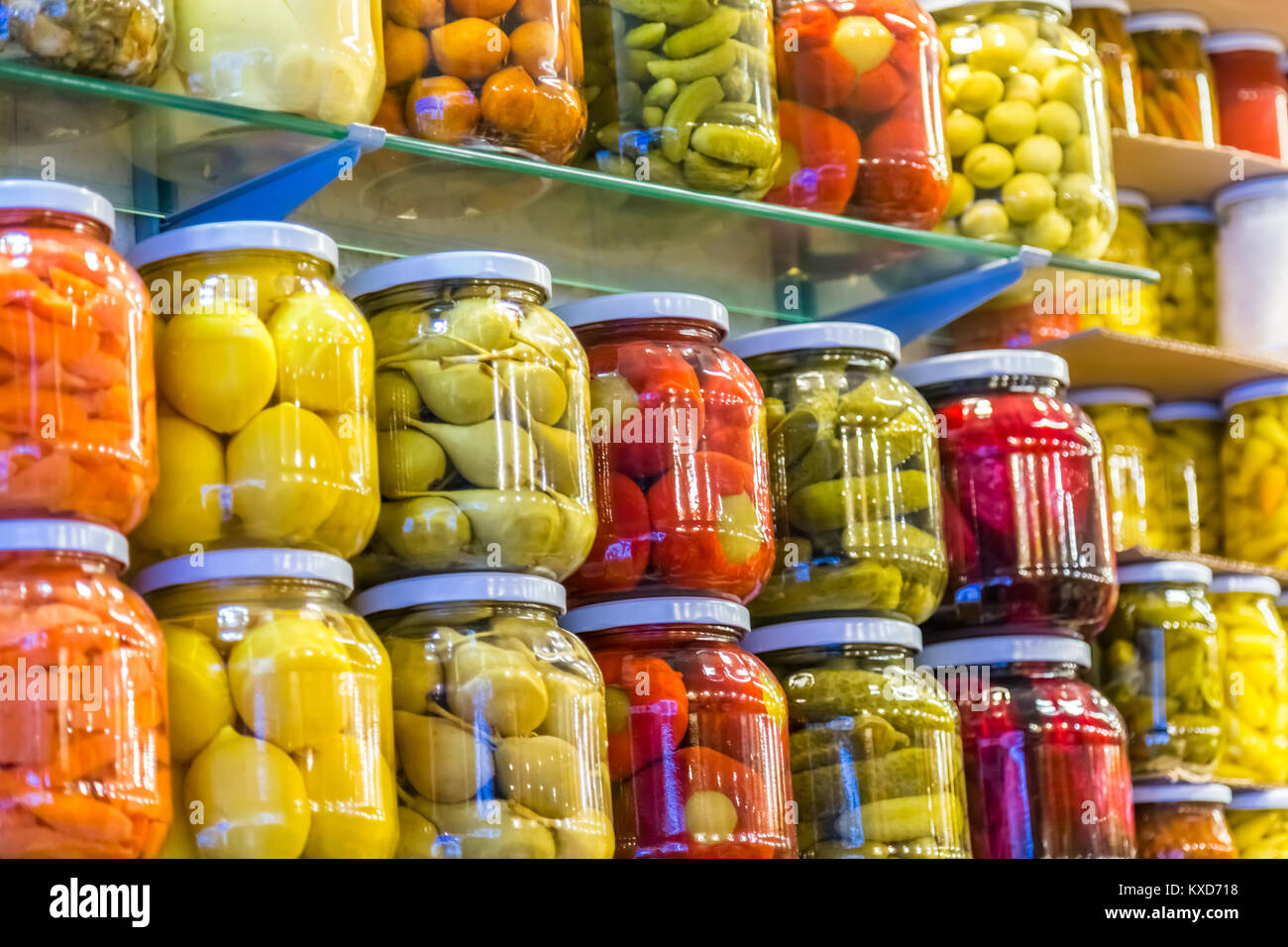 Store shelves with Various pickles in glass jar display for sale Stock