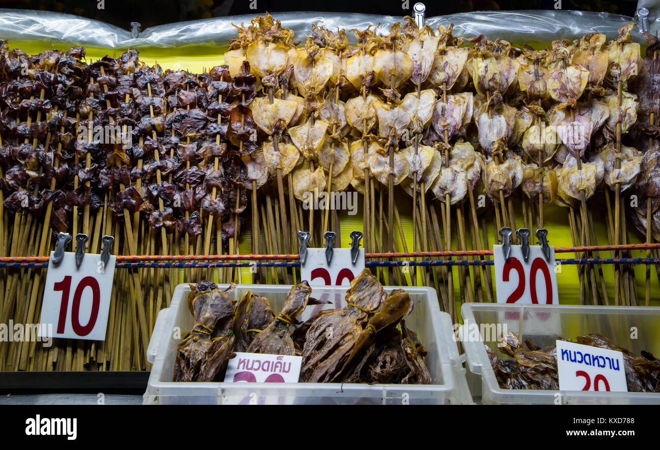 Dried squid on a stick selling on street food in Thailand Stock Photo