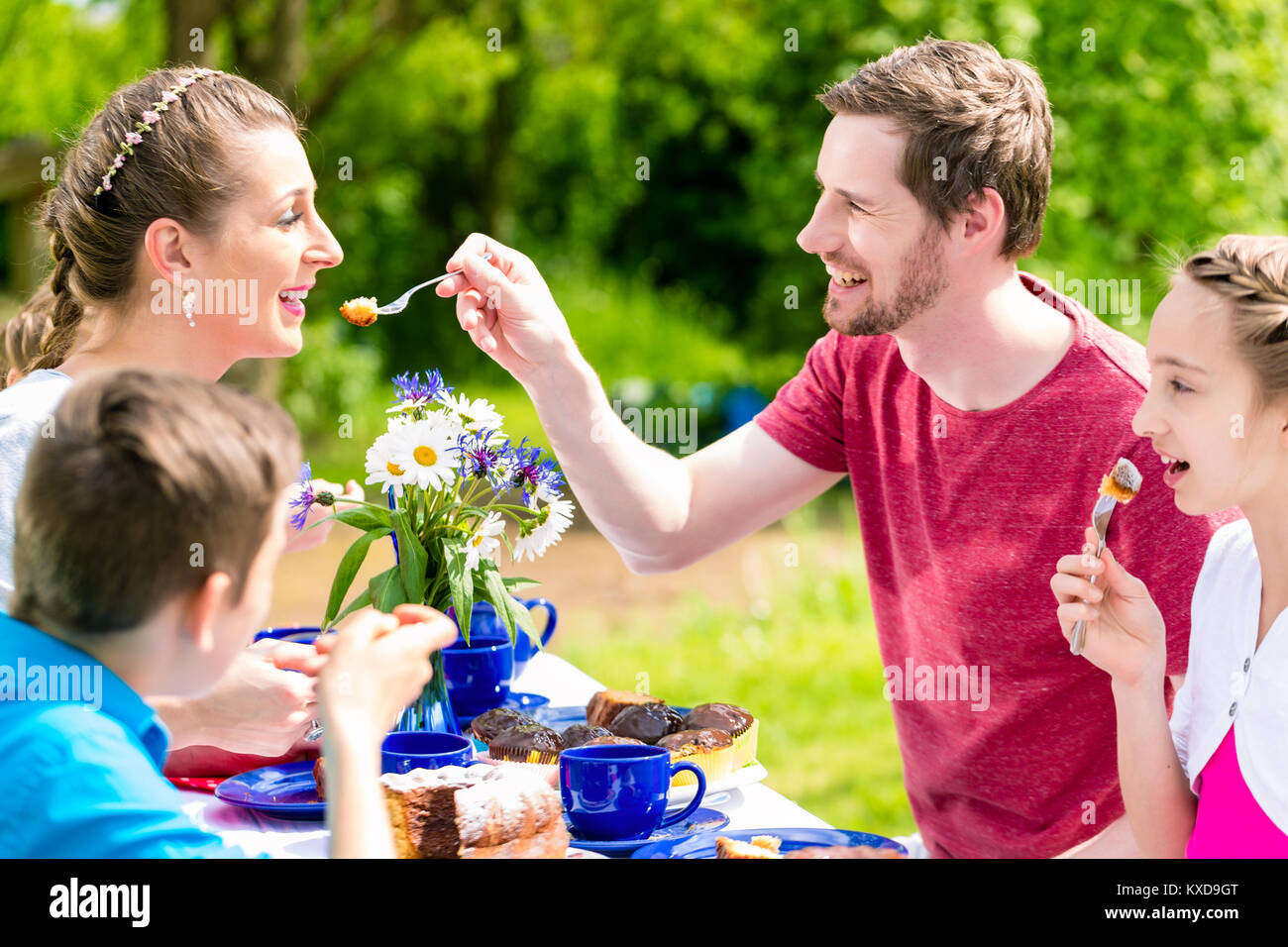 Family having fun at coffee time in garden Stock Photo