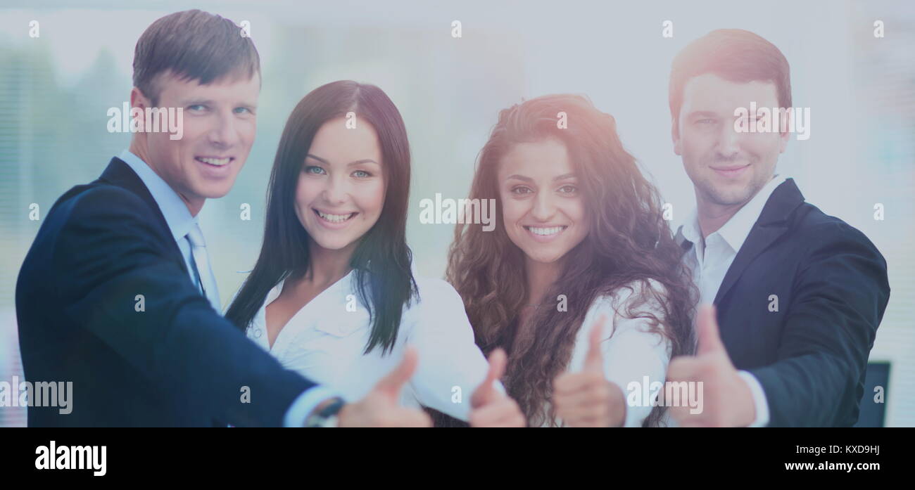 Happy business team with thumbs up in the office Stock Photo - Alamy