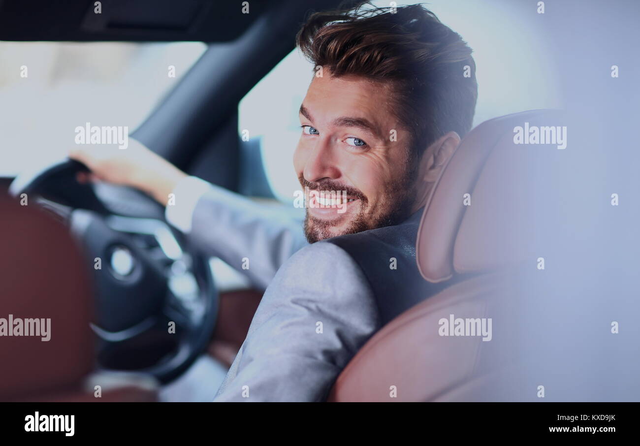 Portrait of an handsome smiling business man driving his car Stock ...