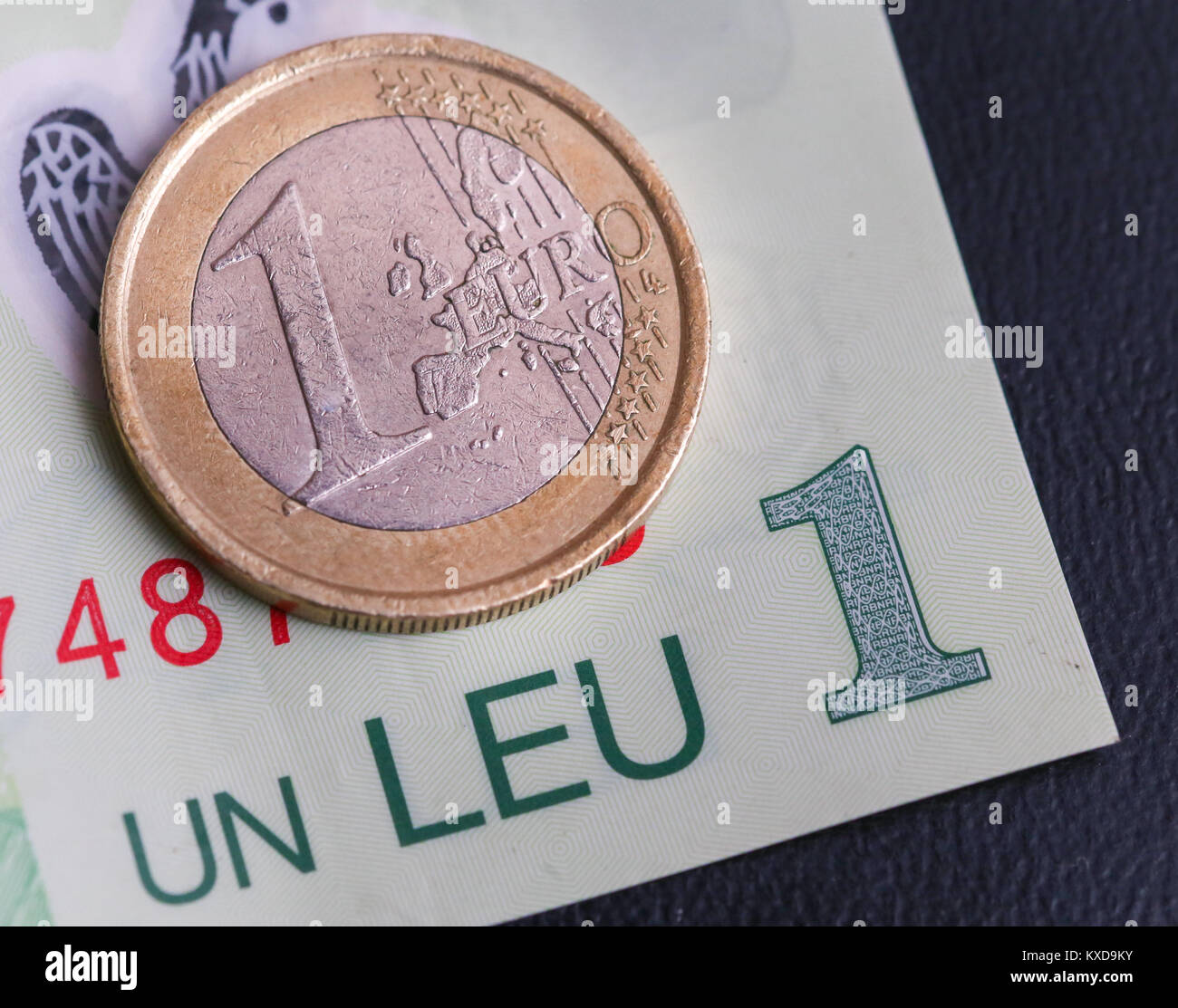 1 euro coin over 1 leu RON bill Stock Photo