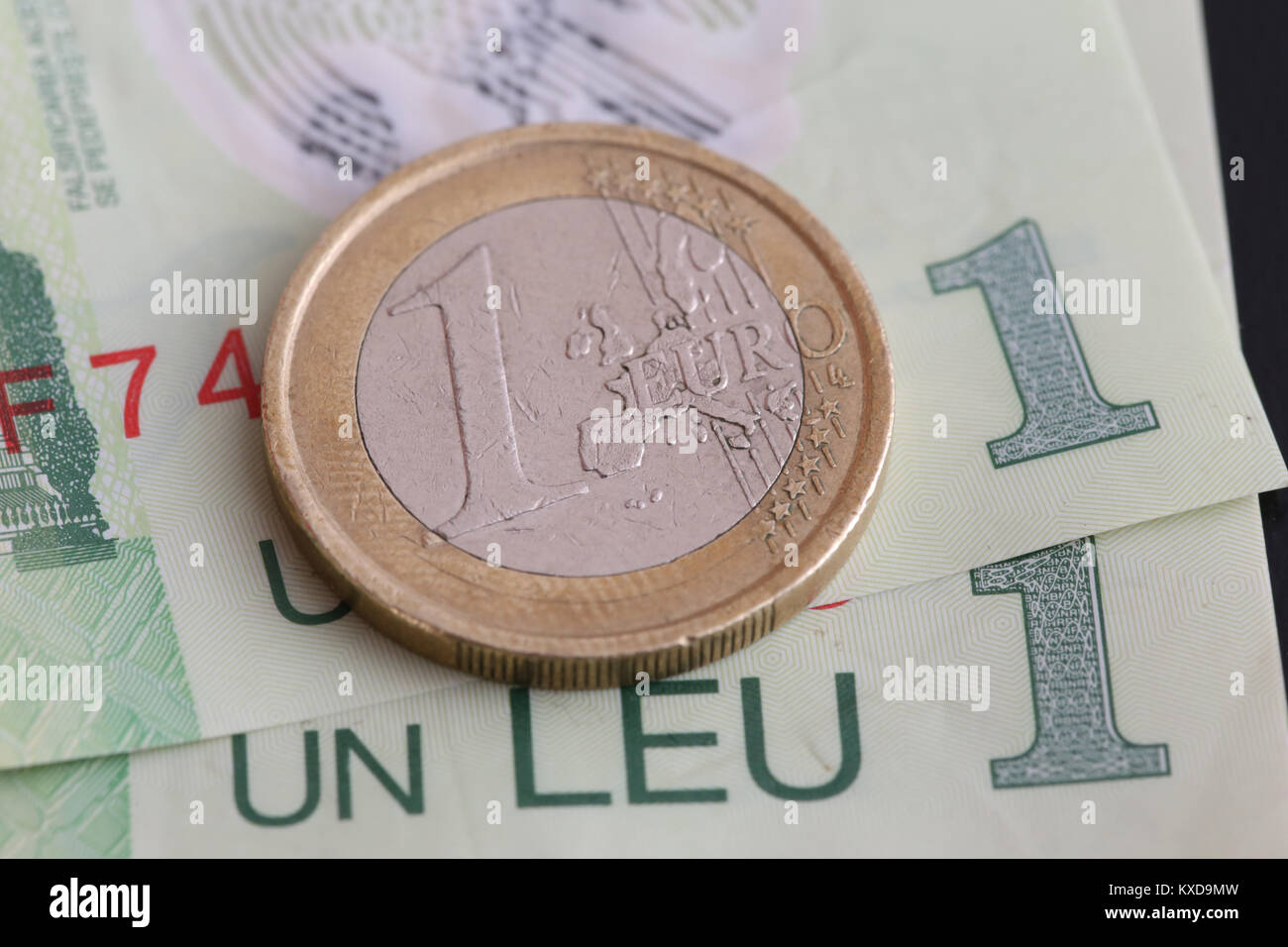 1 euro coin over 1 leu RON bills Stock Photo