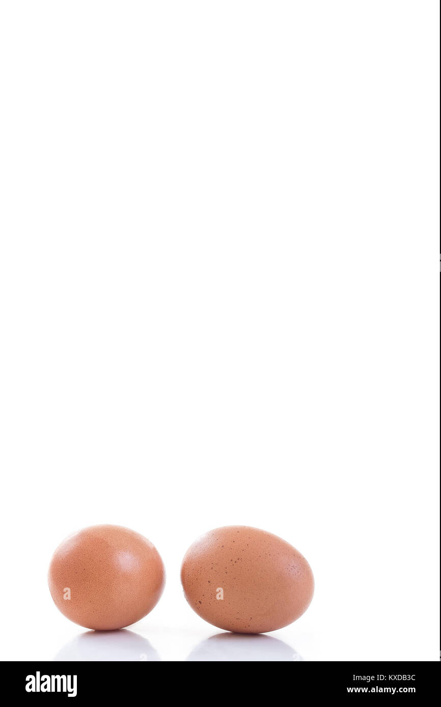 Two Raw eggs isolated on a white background Stock Photo - Alamy