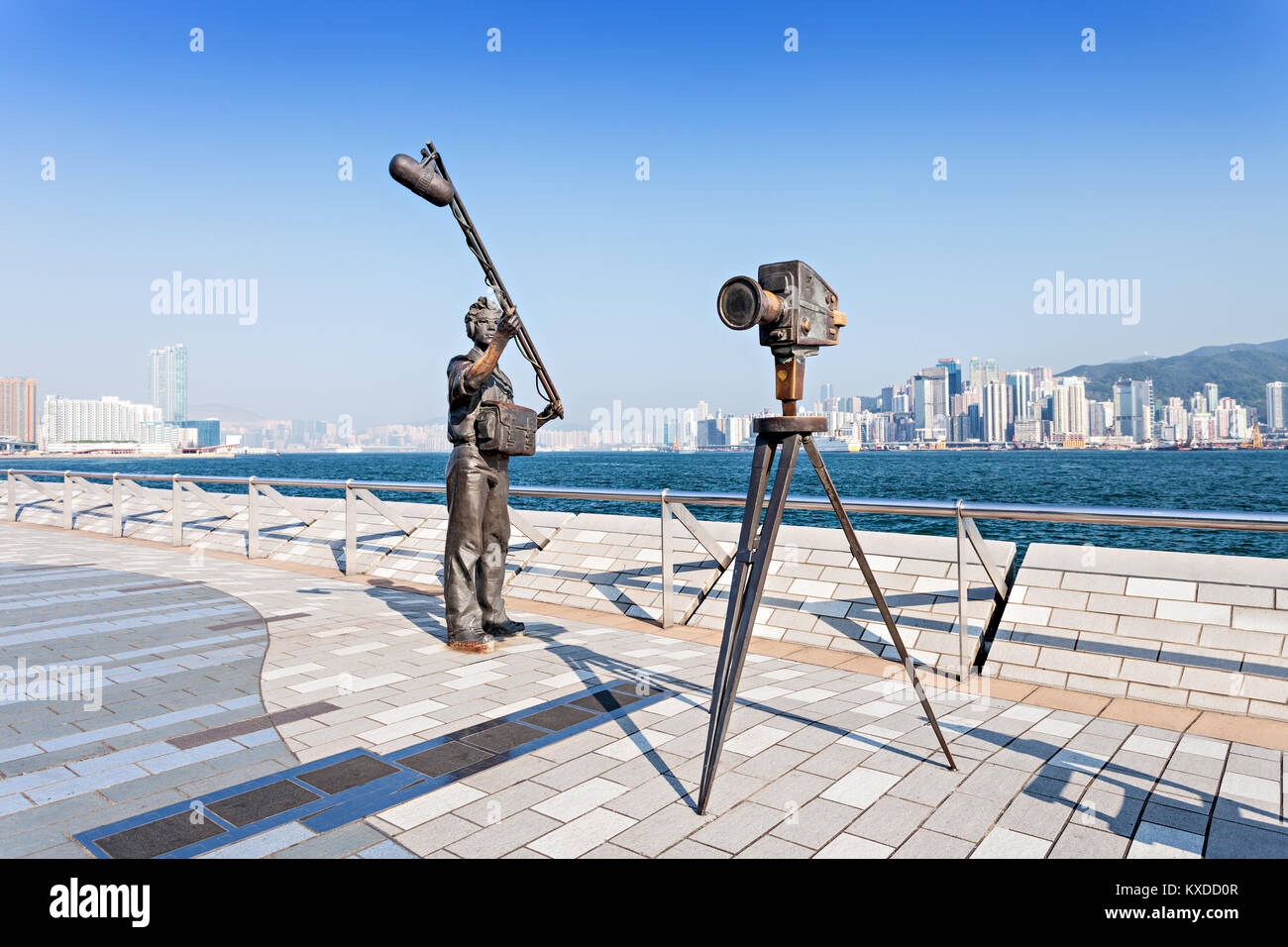 HONG KONG, CHINA - FEBRUARY 21: Statues and skyline on Avenue of Stars on February 21, 2013 in Hong Kong, China. The promenade honours celebrities of  Stock Photo