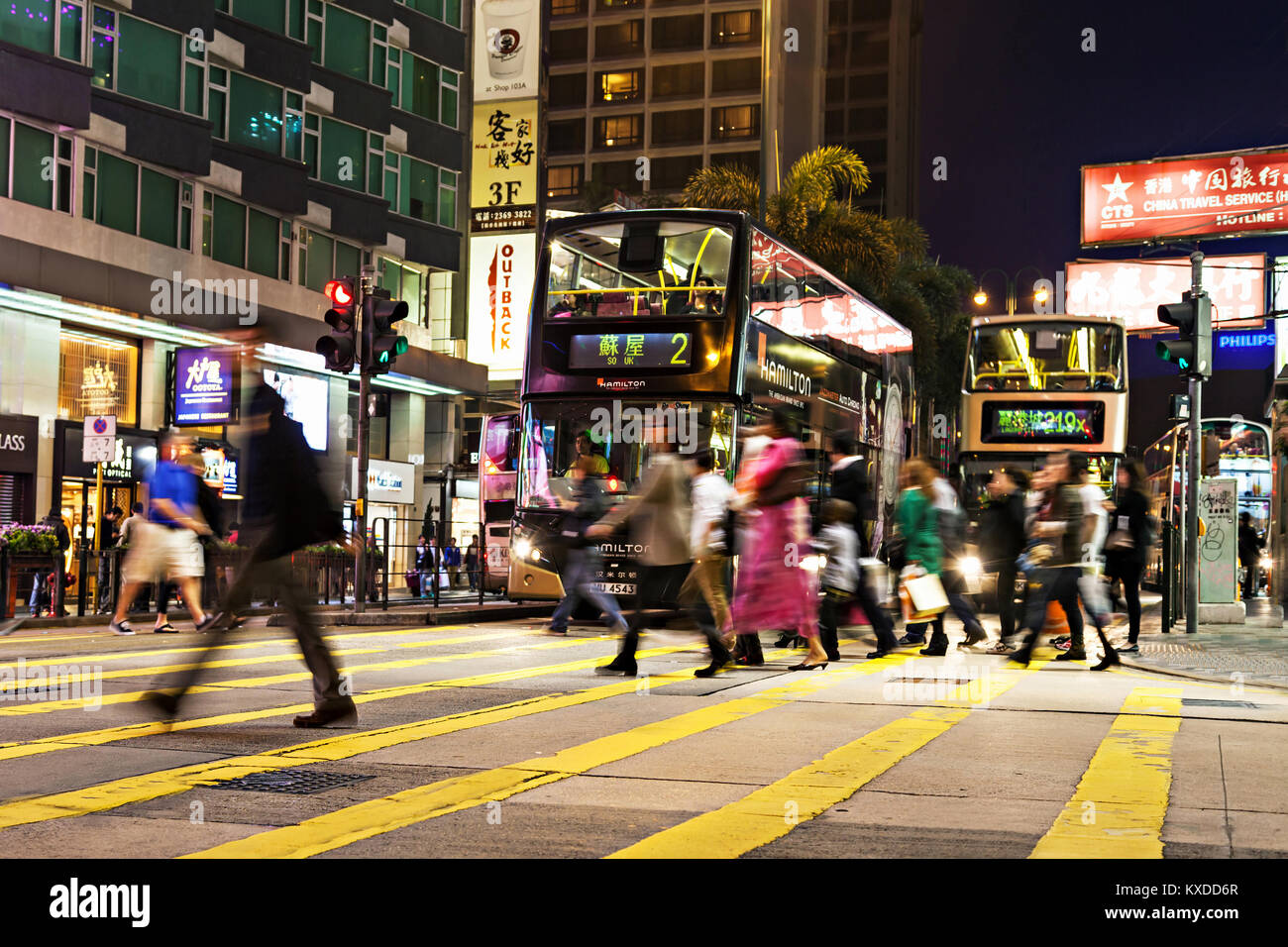 HONG KONG - FEBRUARY 21: Unidentified people crossing the street on February 21, 2013 in Hong Kong. With a 7 million people, Hong Kong is one of the m Stock Photo