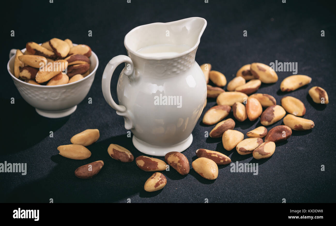 Milk from brazil nuts on black background Stock Photo