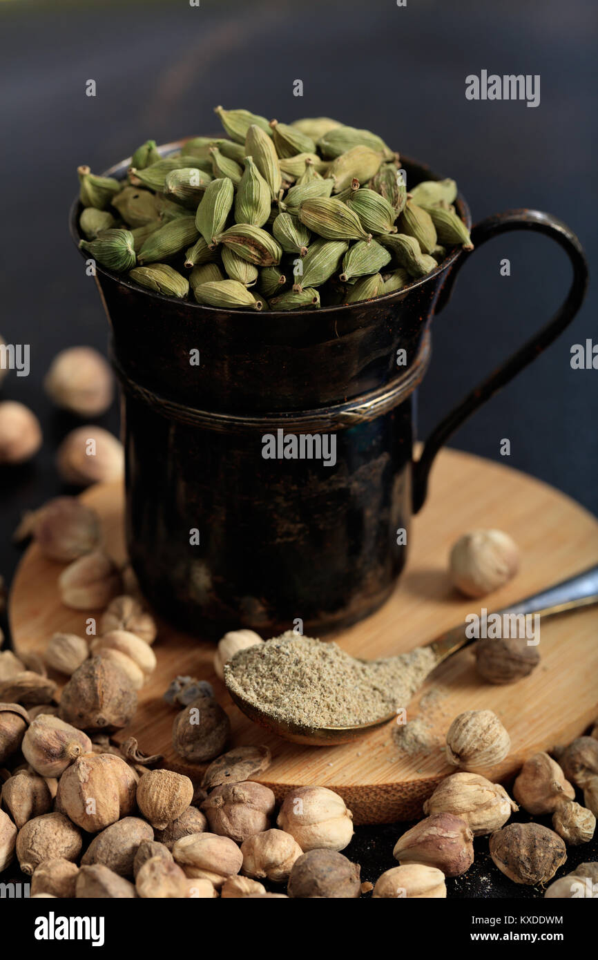 Cardamom seeds and powder on a black background Stock Photo