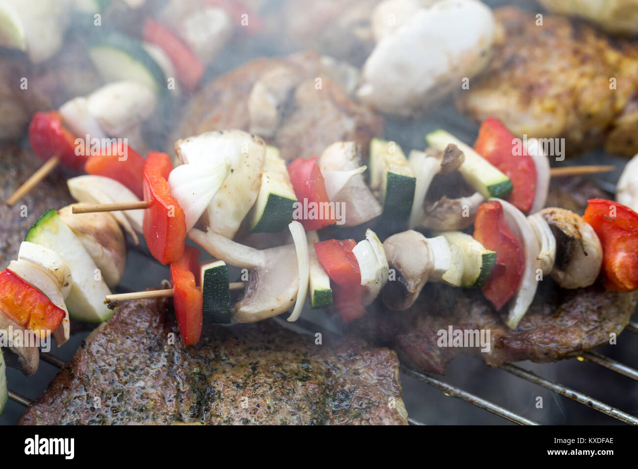 barbecue with delicious grilled meat and vegetables on grill Stock ...