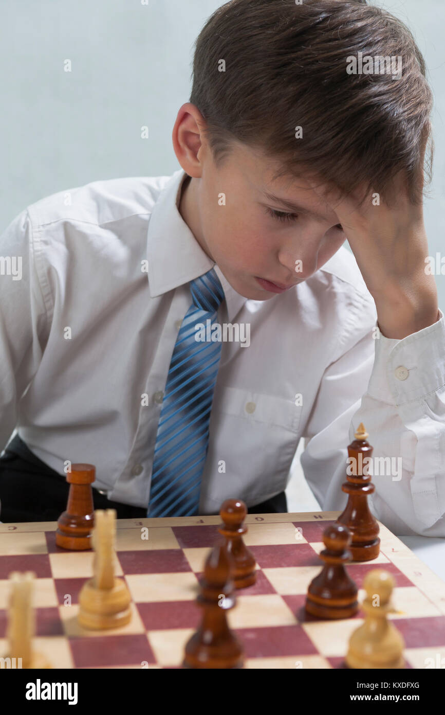 Young chess player ponders stroke Stock Photo