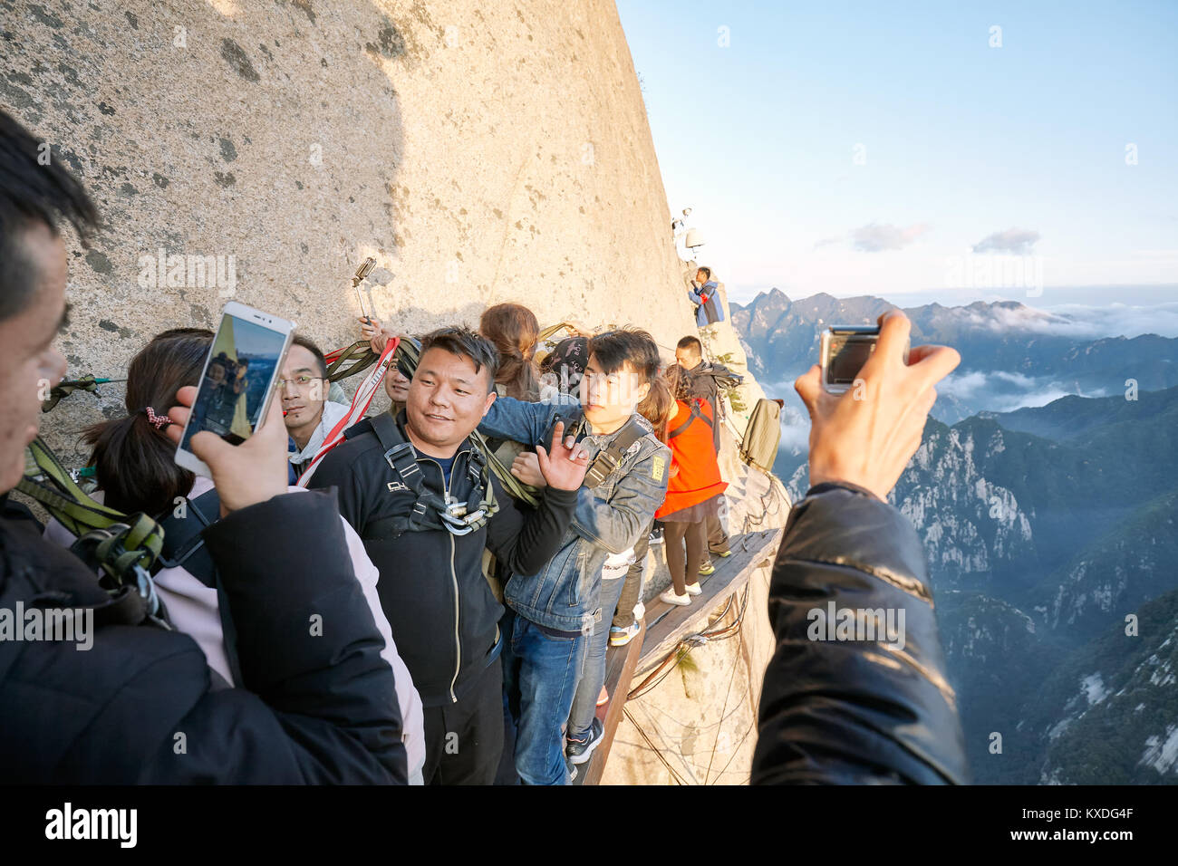 Mount Hua, Shaanxi Province, China - October 6, 2017: Tourists on the Plank Walk in the Sky, worlds most dangerous hike. Stock Photo