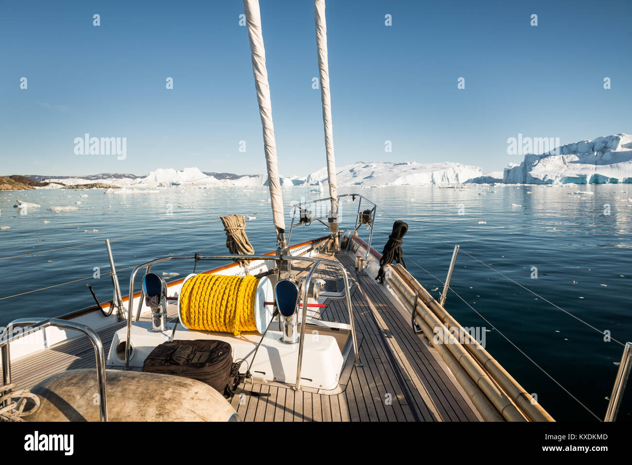 Deck of sailing ship, fjord, rear icebergs, Greenland Stock Photo Alamy