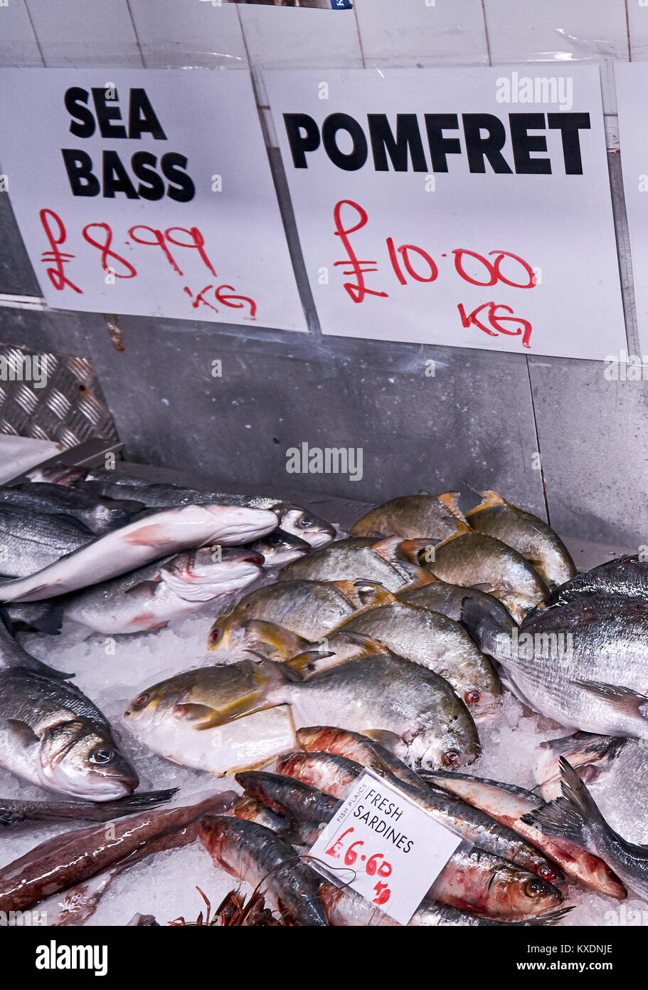 Fresh fish in ice at a local fishmonger. Stock Photo