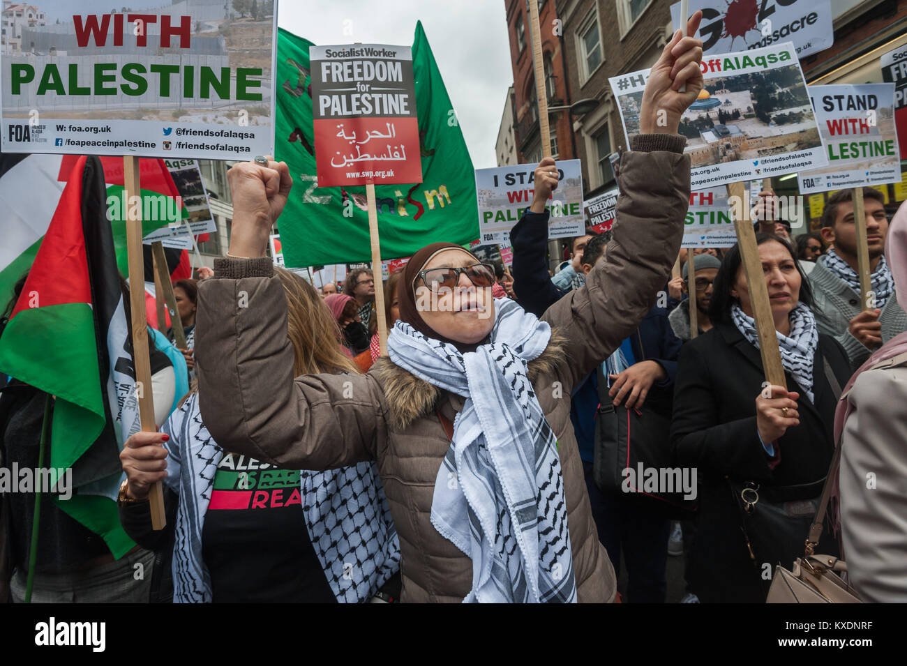 A woman waves her fist at the protest at Israeli embassy in London calleing for an end to Israeli occupation and repression and Freedom for Palestine. Stock Photo