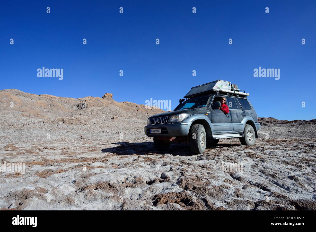 Off-road vehicle on the road in the valley of the moon, Valle de la Luna, San Pedro de Atacama, Antofagasta, Chile Stock Photo