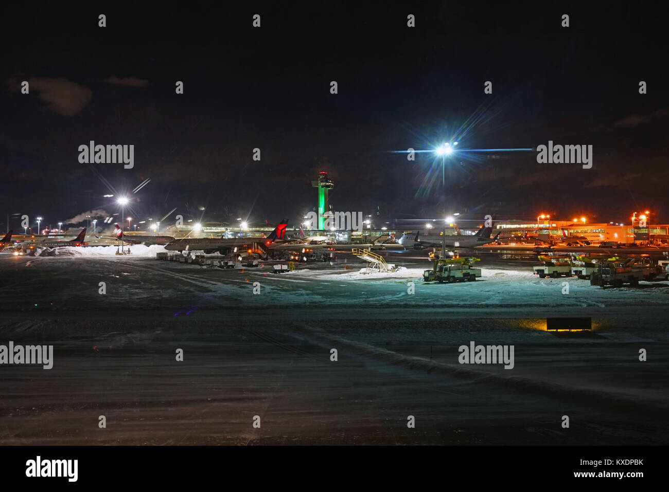 Night view of the operations mess and delays at the John F. Kennedy International Airport (JFK) after the bomb cyclone winter snow storm Grayson. Stock Photo