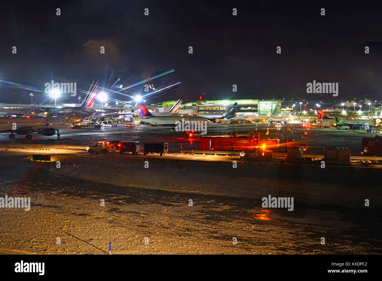 Night view of the operations mess and delays at the John F. Kennedy International Airport (JFK) after the bomb cyclone winter snow storm Grayson. Stock Photo