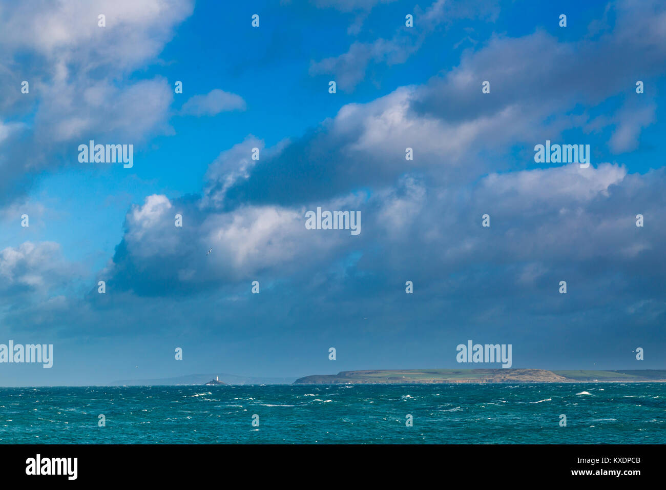 Godrevy Lighthouse as viewed from St Ives in Cornwall across the choppy sea. Popular British tourism location. Stock Photo