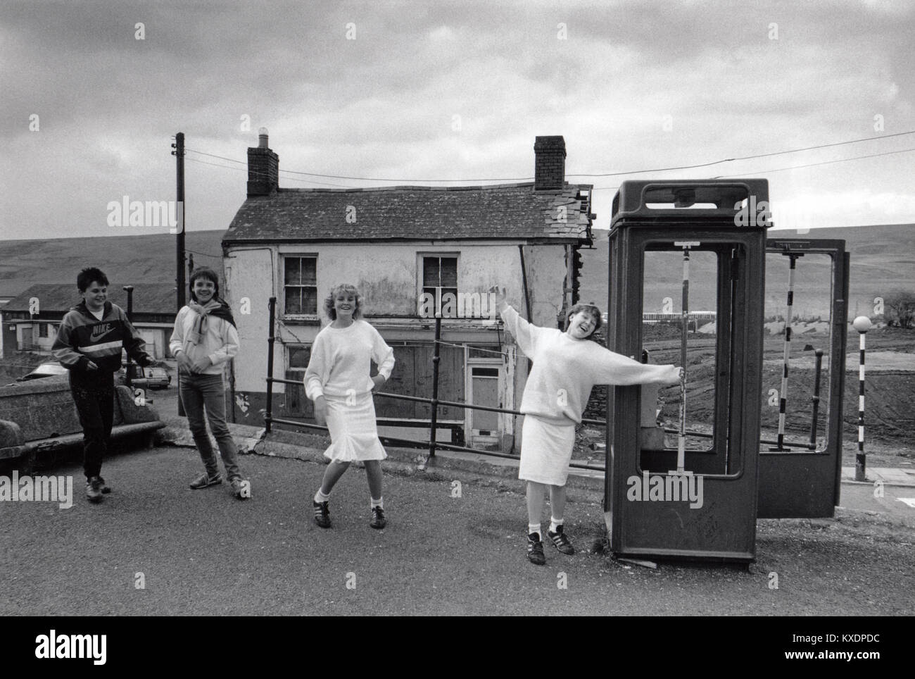 UK, Wales, Rhymney, Social History, children playing by derelict K8 phone box 1970s Stock Photo