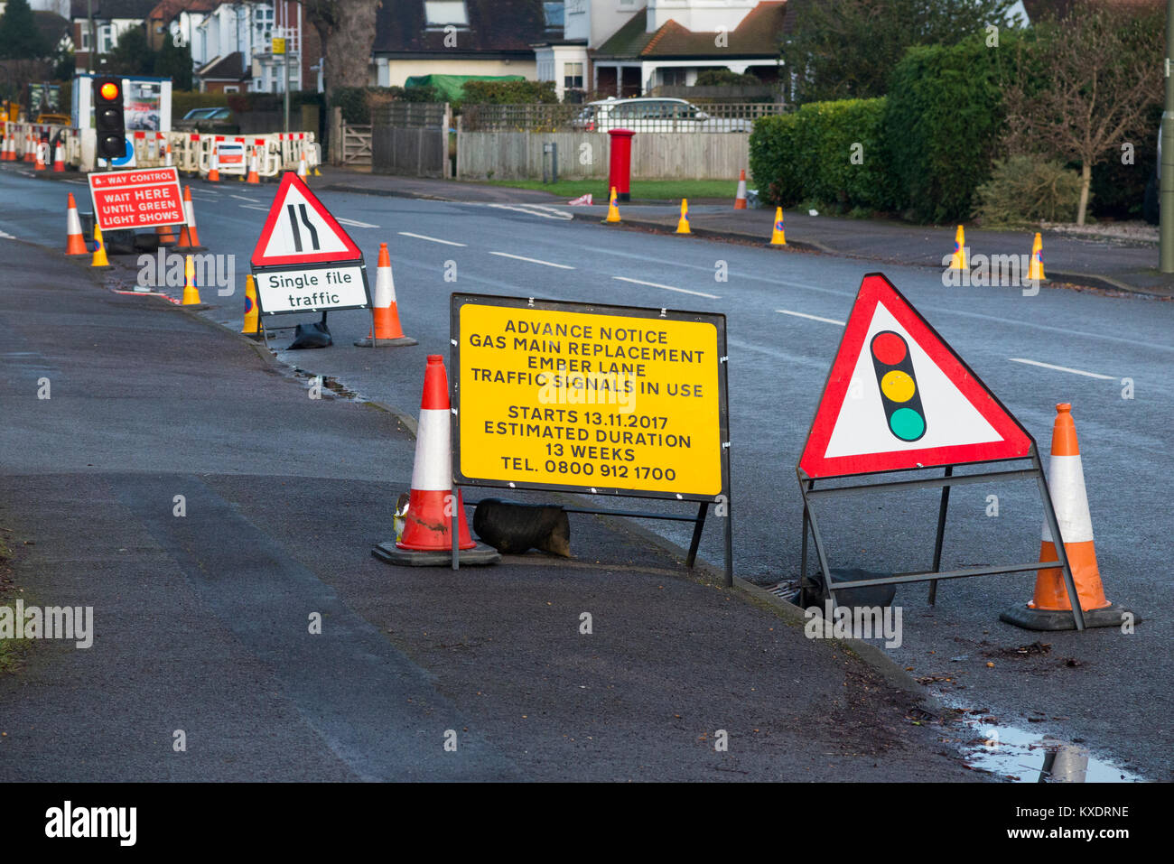 Temporary roadworks with traffic light signals and cones / sign / signs