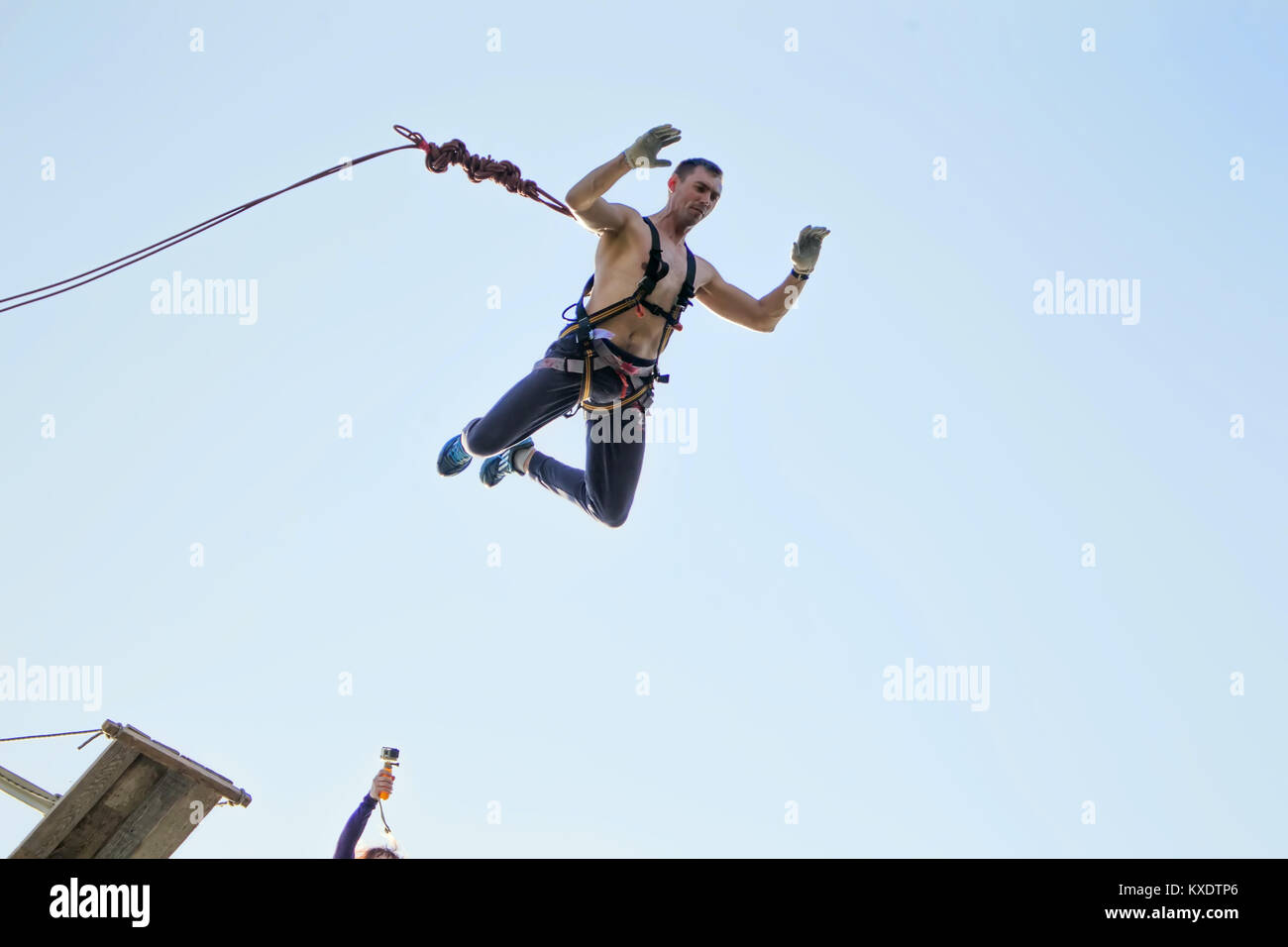 Belarus, Gomel, May 01  2017.Jumping with a rope.The extreme guy jumped from a huge height.Ropejumping. Stock Photo