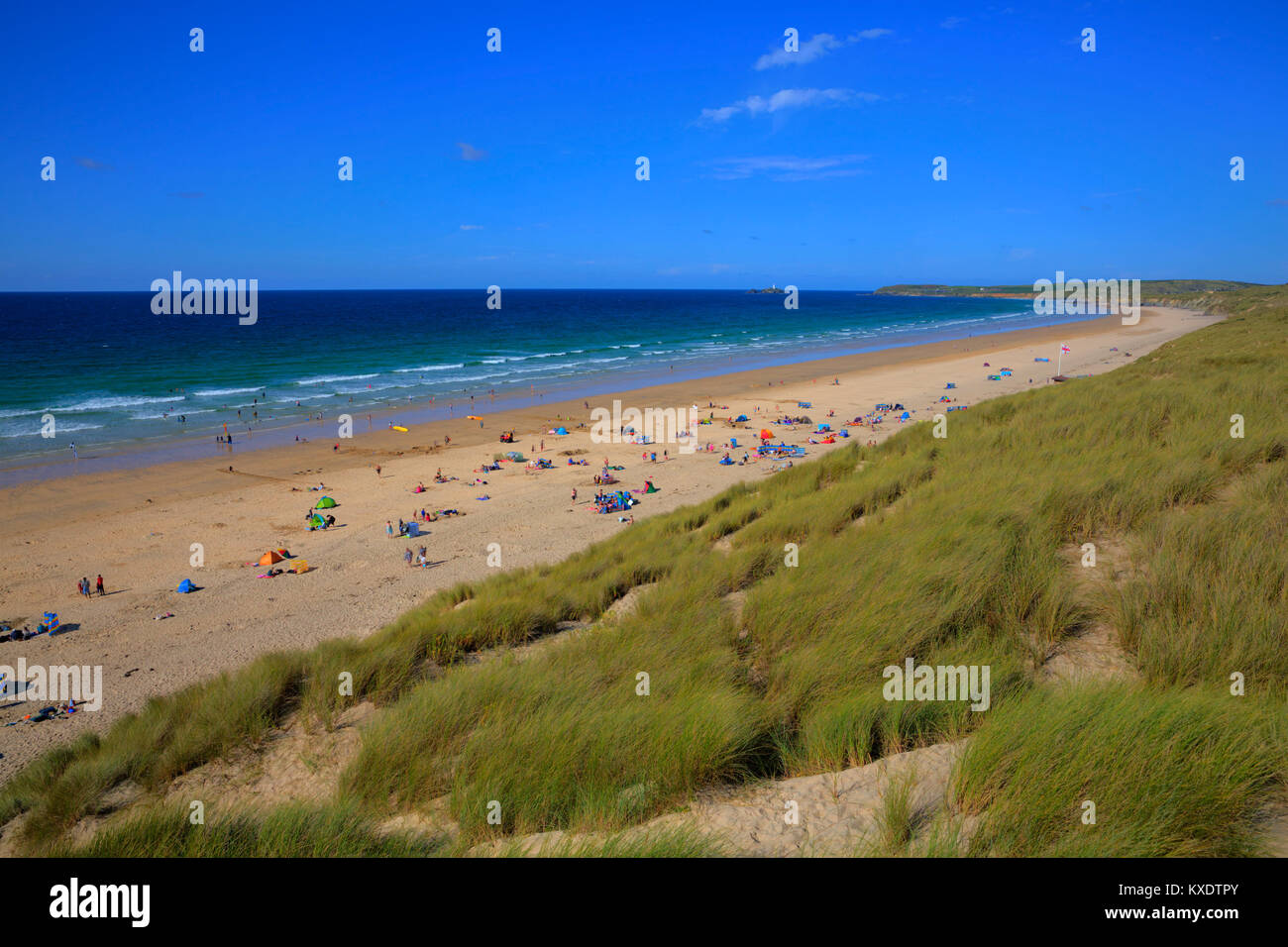 St Ives Bay beach Cornwall uk in summer with people blue sky and sea, view towards Godrevy lighthouse Stock Photo